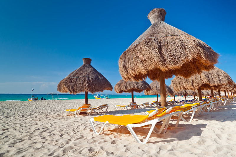 Lounge chairs and tiki huts on the beach